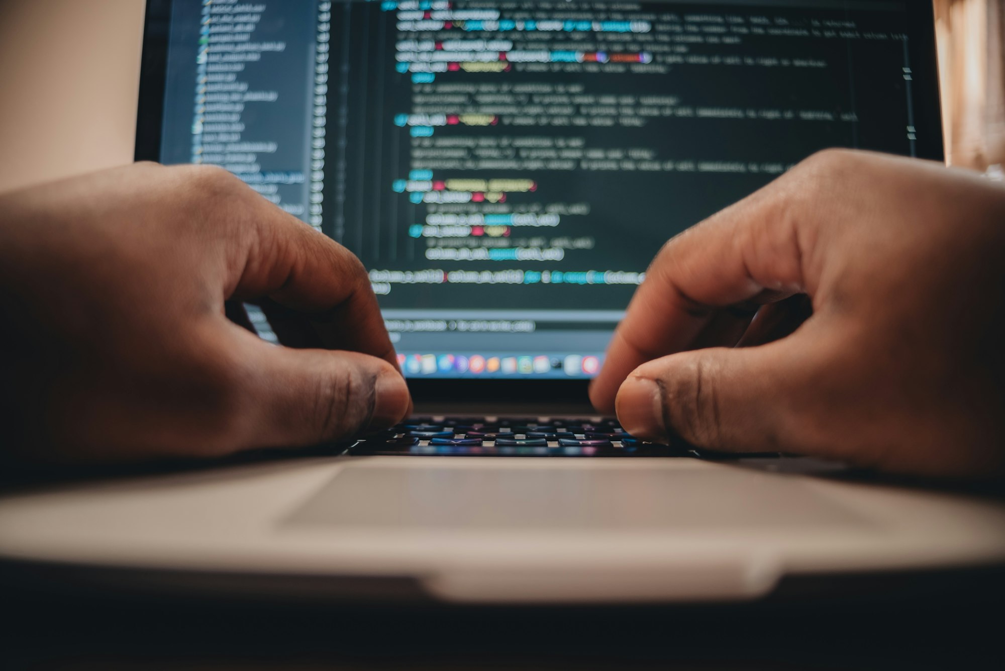 African American man sitting in front of computer coding, programming, web developer